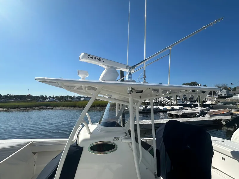 Slide: The Image of 2018 Regulator 28 boat with Garmin radar, docked by the water under clear blue sky. - 4