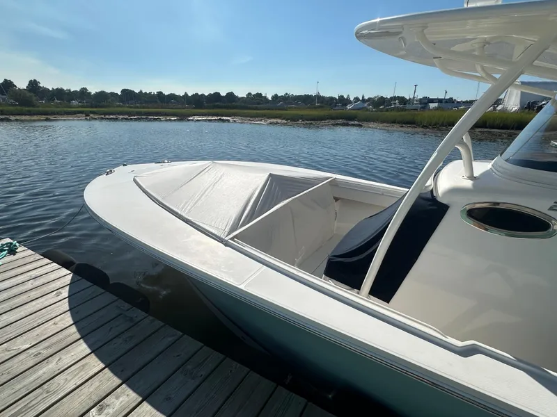 Slide: The Image of 2018 Regulator 28 boat docked on calm water under clear blue sky. - 5