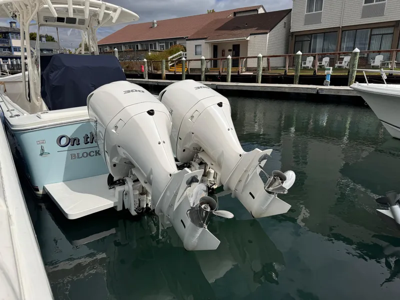 Slide: The Image of 2018 Regulator 28 boat with twin outboard engines docked in marina. - 6