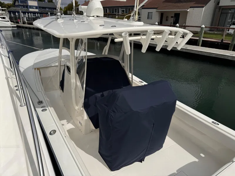 Slide: The Image of 2018 Regulator 28 boat with covered seating, docked in a marina. - 7
