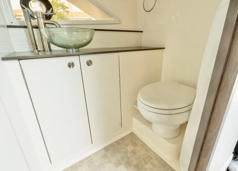 Slide: The Image of Modern bathroom in 2020 Sea Ray Sundancer 320 yacht with glass sink and toilet. - 21