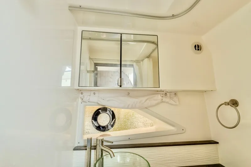 Slide: The Image of Interior of 2020 Sea Ray Sundancer 320 yacht bathroom with mirror and porthole. - 22