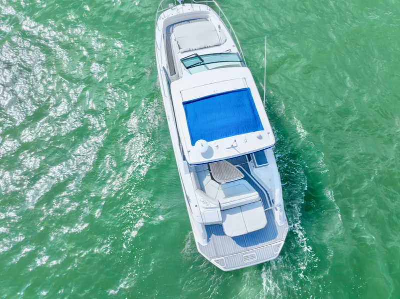 Slide: The Image of Aerial view of 2020 Sea Ray Sundancer 320 cruising on turquoise water. - 8