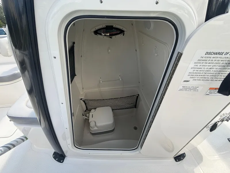Slide: The Image of 2025 Sailfish 241 CC boat interior with compact marine toilet. - 14