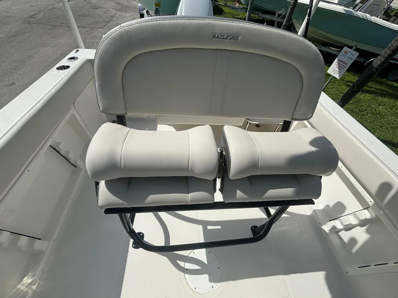 Slide: The Image of 2025 Sailfish 241 CC boat seating, featuring cushioned dual seats and sturdy frame. - 16