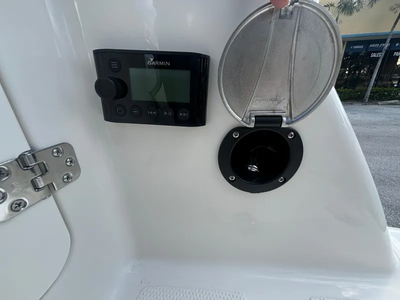 Slide: The Image of Garmin device and compartment on 2025 Sailfish 241 CC boat dashboard. - 18