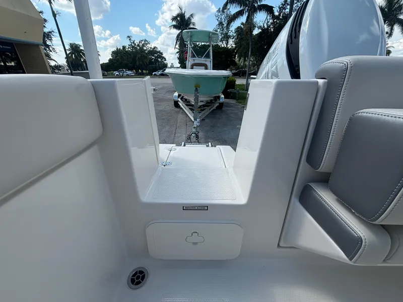 Slide: The Image of 2025 Sailfish 241 CC boat interior with seating and view of trailer. - 19
