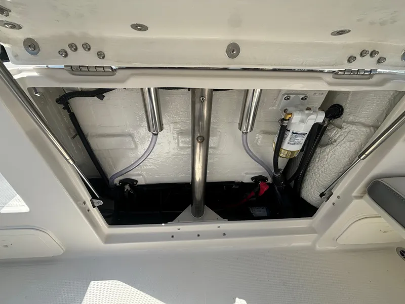 Slide: The Image of 2025 Sailfish 241 CC boat interior compartment with mechanical components and wiring. - 21