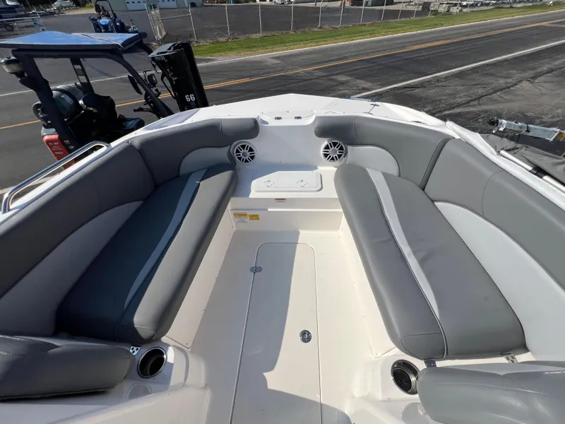 Slide: The Image of 2023 NauticStar 203 DC boat interior with gray seating and cup holders. - 11