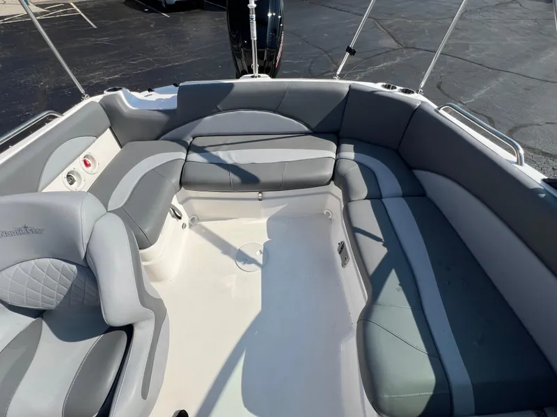 Slide: The Image of 2023 NauticStar 203 DC boat interior with gray seating and spacious layout. - 12