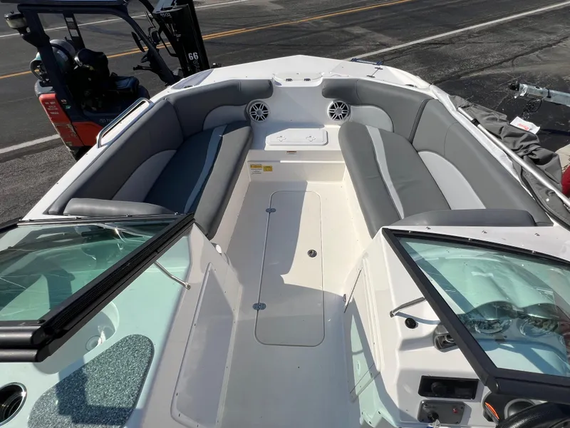 Slide: The Image of 2023 NauticStar 203 DC boat interior with gray seating and open deck layout. - 13