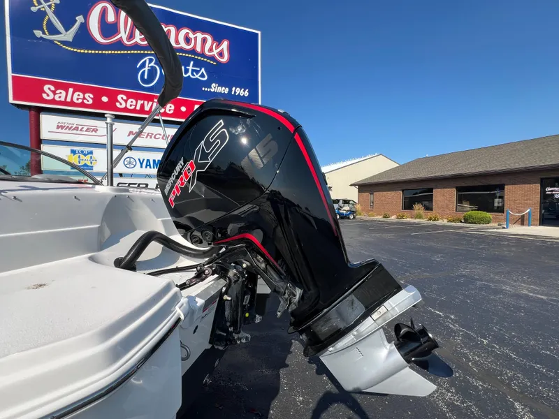 Slide: The Image of 2023 NauticStar 203 DC boat with powerful outboard motor at Clemons Boats dealership. - 4