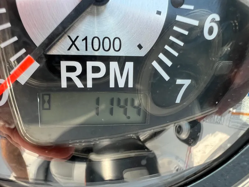 Slide: The Image of Tachometer displaying 1144 RPM on a 2023 NauticStar 203 DC boat. - 7