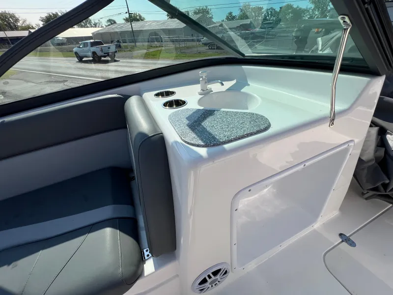 Slide: The Image of 2023 NauticStar 203 DC boat interior with seating and sink area. - 9