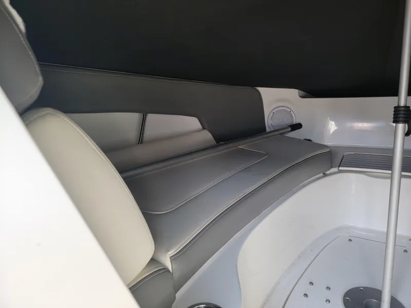 Slide: The Image of 2011 Sea Ray 240 Sundeck interior with cushioned seating and sleek design. - 11