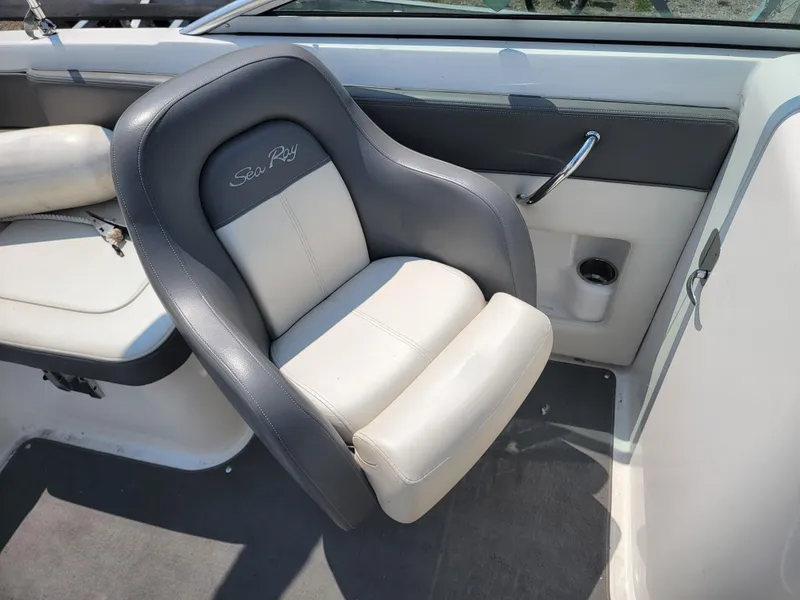 Slide: The Image of 2011 Sea Ray 240 Sundeck boat seat with gray and white upholstery. - 16