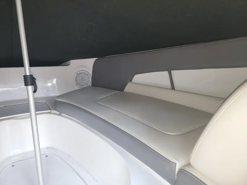 Slide: The Image of 2011 Sea Ray 240 Sundeck interior seating with gray and white upholstery. - 9