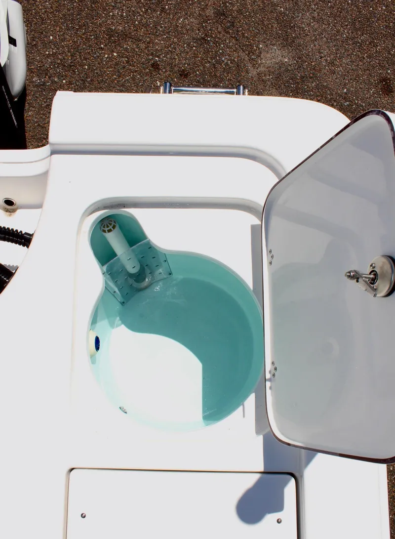 Slide: The Image of Livewell on 2025 Sea Pro 230 Bay boat, open lid, filled with water. - 13