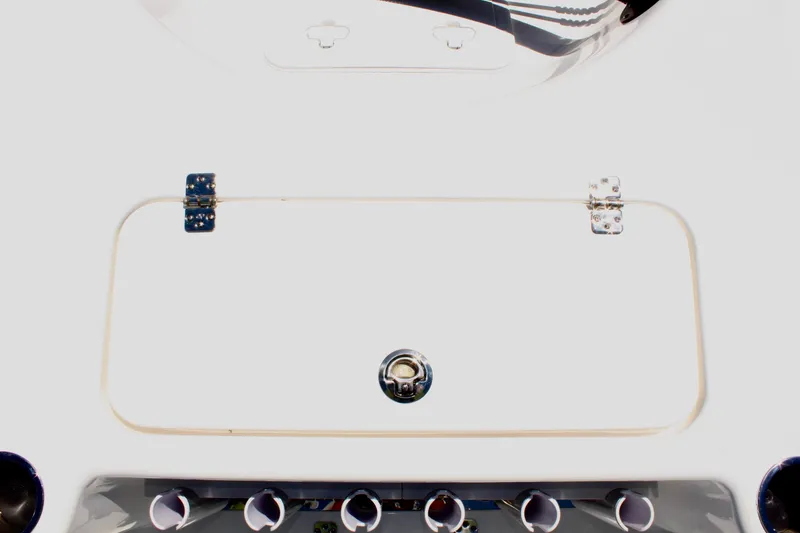 Slide: The Image of 2025 Sea Pro 230 Bay boat storage compartment with latch and hinges. - 14