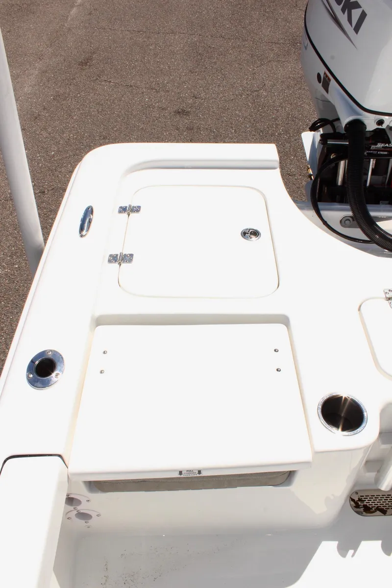 Slide: The Image of 2025 Sea Pro 230 Bay boat deck with storage compartments and cup holders. - 17