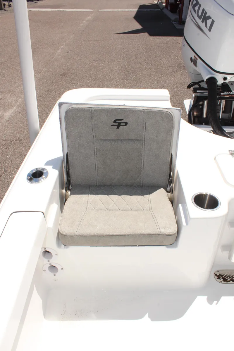 Slide: The Image of 2025 Sea Pro 230 Bay boat seat with Suzuki engine in background. - 18