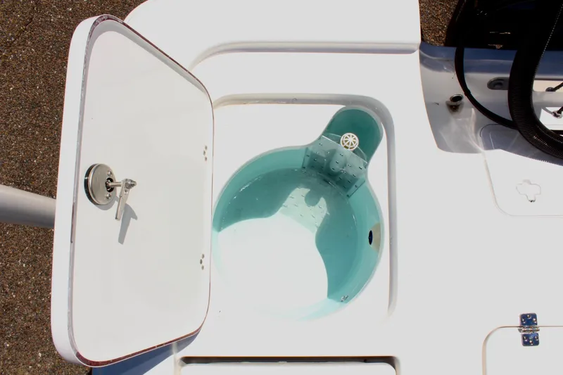 Slide: The Image of Livewell compartment on 2025 Sea Pro 230 Bay boat, open lid, filled with water. - 19