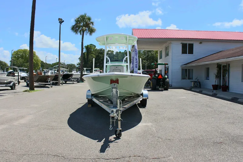 Slide: The Image of 2025 Sea Pro 230 Bay boat on trailer in marina parking lot. - 2