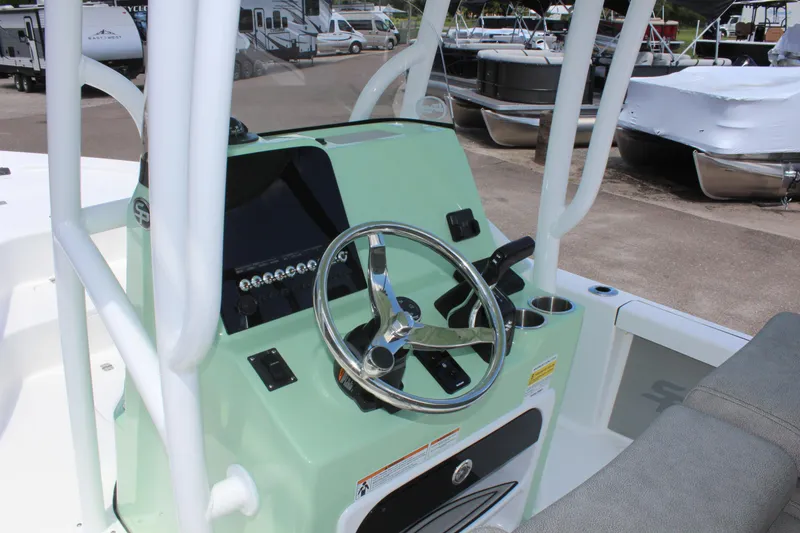 Slide: The Image of 2025 Sea Pro 230 Bay boat console with steering wheel and controls. - 29