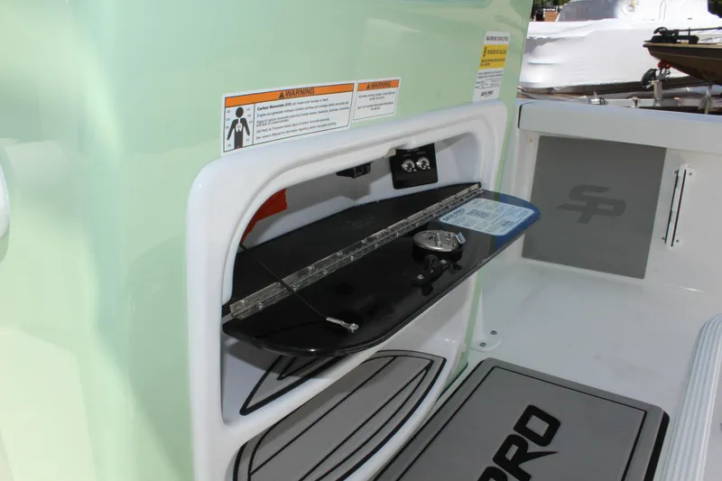 Slide: The Image of 2025 Sea Pro 230 Bay boat storage compartment with gauge and ruler. - 30