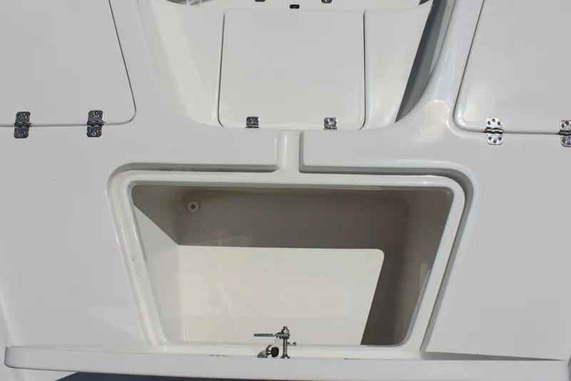 Slide: The Image of 2025 Sea Pro 230 Bay boat storage compartment, white interior, open hatch. - 36