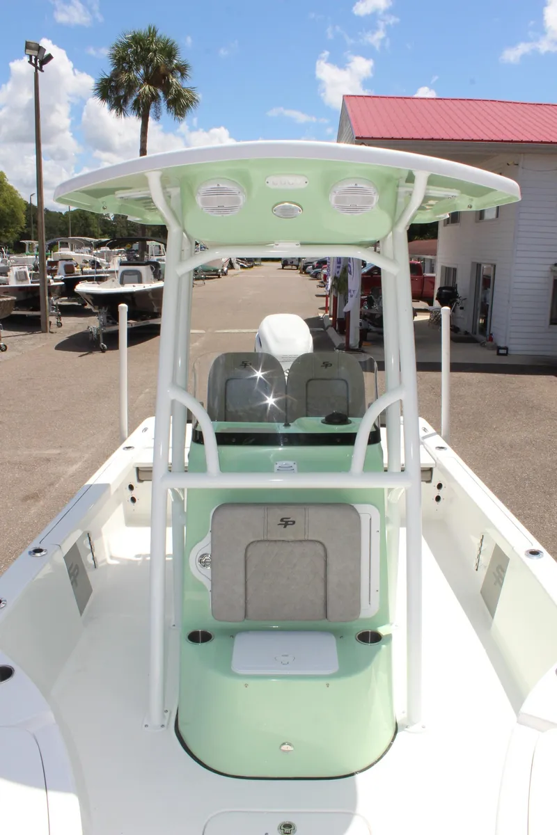 Slide: The Image of 2025 Sea Pro 230 Bay boat with T-top, docked under blue sky. - 39