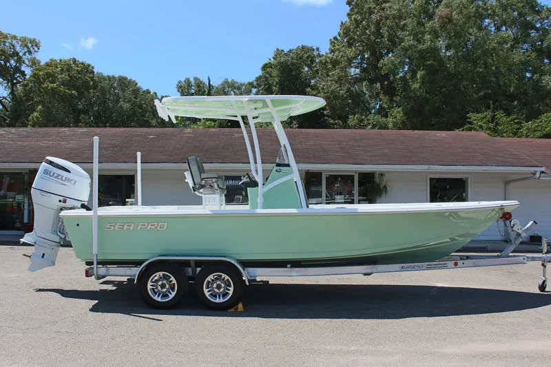 Slide: The Image of 2025 Sea Pro 230 Bay boat on trailer, mint green hull, Suzuki outboard motor. - 4