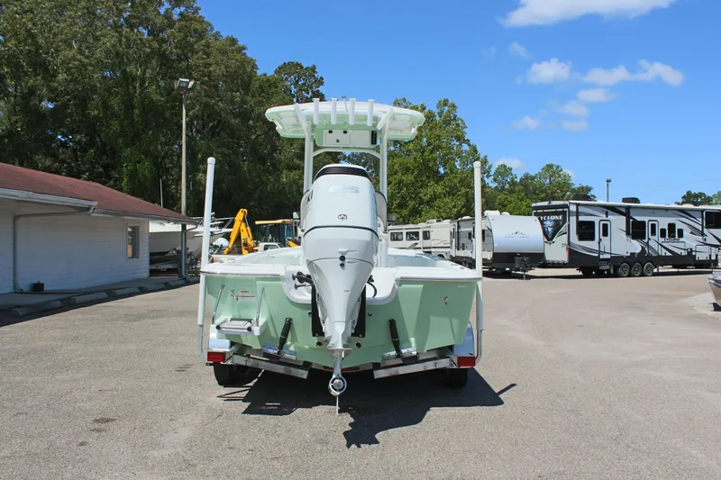 Slide: The Image of 2025 Sea Pro 230 Bay boat, rear view, parked outdoors on a sunny day. - 6