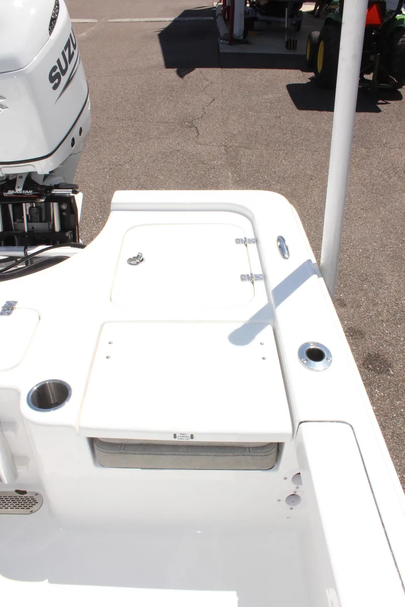 Slide: The Image of 2025 Sea Pro 230 Bay boat deck with Suzuki engine, featuring storage compartments. - 8