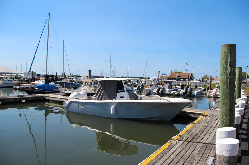 Slide: The Image of 2025 Sea Hunt Gamefish 28 docked at a marina under clear blue skies. - 10