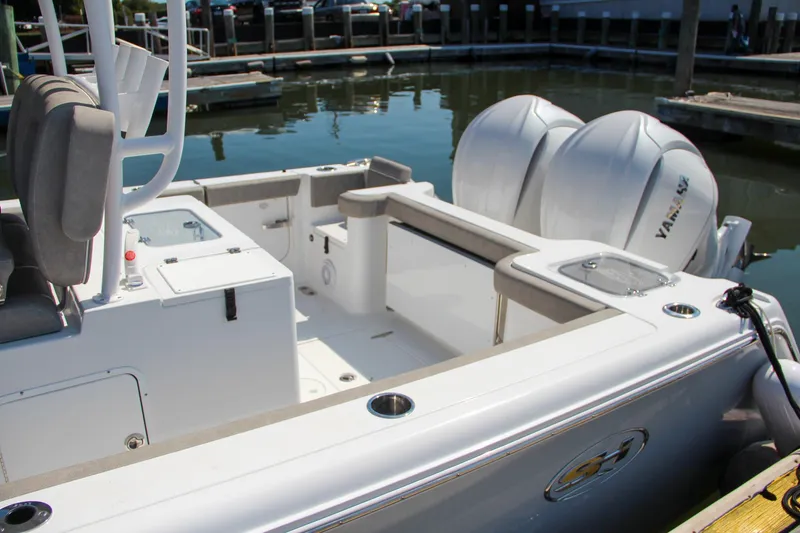 Slide: The Image of 2025 Sea Hunt Gamefish 28 boat with dual Yamaha engines docked at marina. - 11