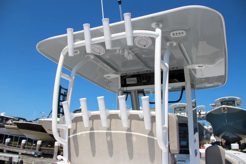 Slide: The Image of 2025 Sea Hunt Gamefish 28 boat with rod holders and T-top in marina. - 21