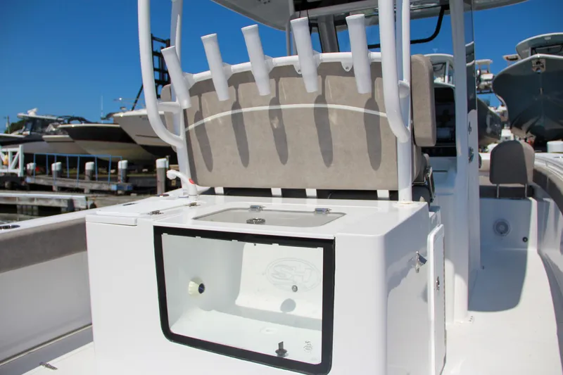 Slide: The Image of 2025 Sea Hunt Gamefish 28 boat interior with rod holders and storage compartment. - 22