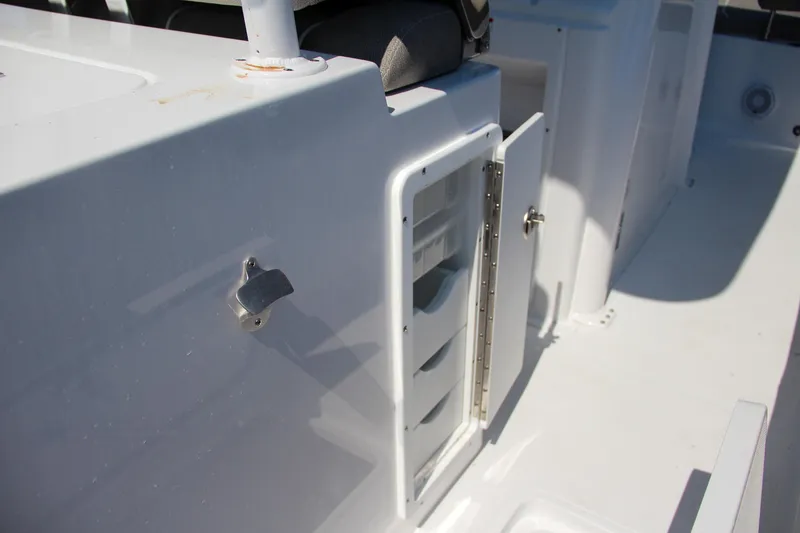 Slide: The Image of 2025 Sea Hunt Gamefish 28 boat storage compartment with open door. - 24
