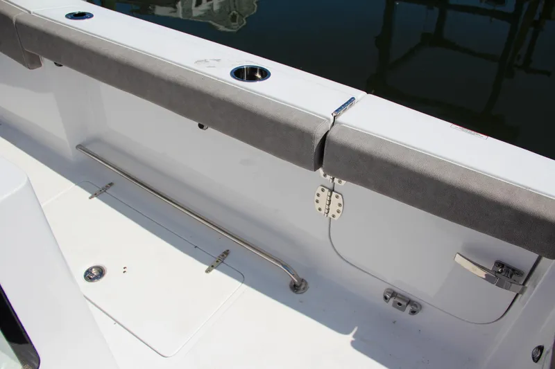 Slide: The Image of 2025 Sea Hunt Gamefish 28 boat interior with rod holders and cushioned seating. - 26