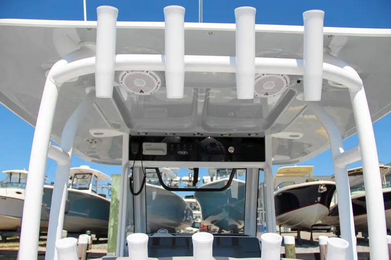 Slide: The Image of 2025 Sea Hunt Gamefish 28 boat with rod holders and overhead console. - 28