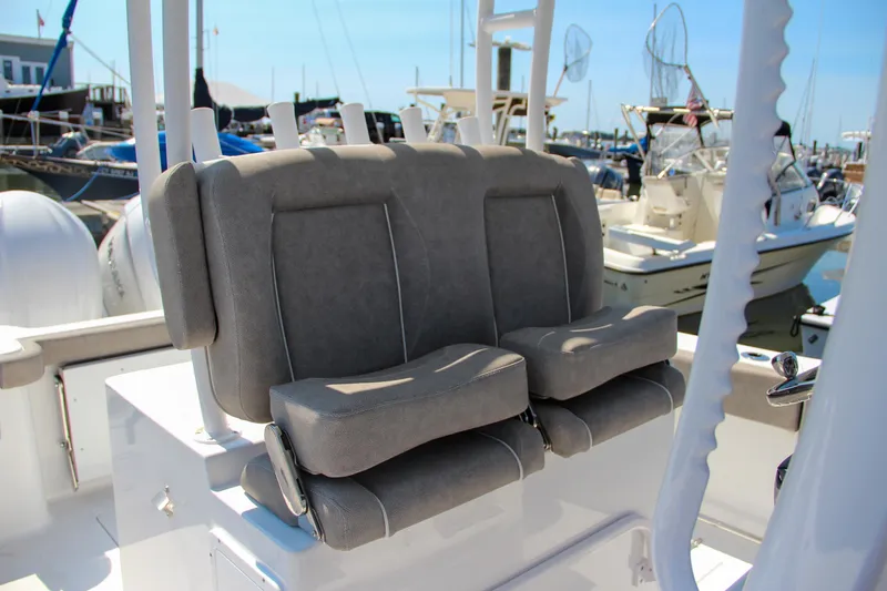 Slide: The Image of 2025 Sea Hunt Gamefish 28 boat seats at marina, featuring comfortable gray upholstery. - 30