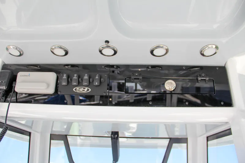 Slide: The Image of 2025 Sea Hunt Gamefish 28 boat dashboard with controls and switches. - 33