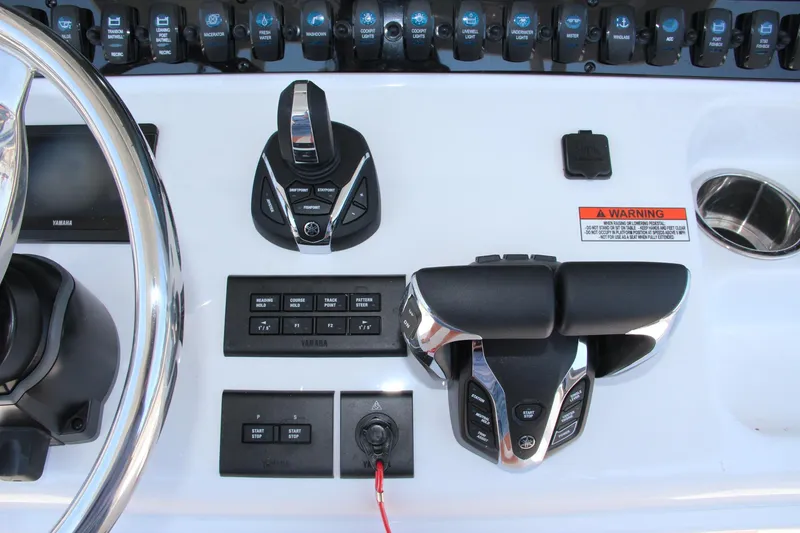 Slide: The Image of Control panel of 2025 Sea Hunt Gamefish 28 boat with steering wheel and throttle. - 34