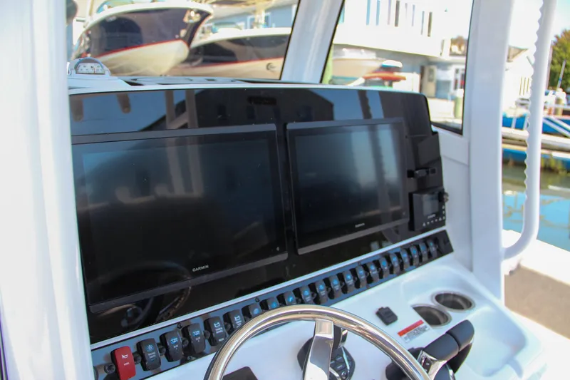 Slide: The Image of 2025 Sea Hunt Gamefish 28 boat dashboard with dual screens and controls. - 36