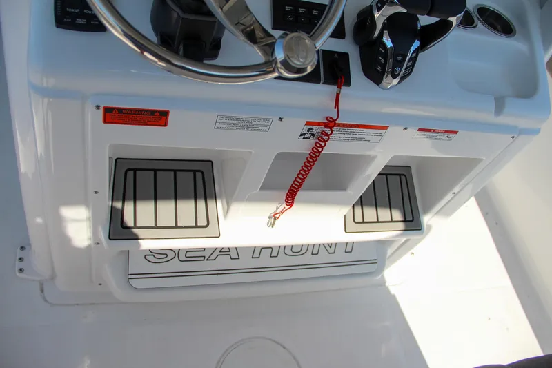 Slide: The Image of 2025 Sea Hunt Gamefish 28 boat console with steering wheel and controls. - 37
