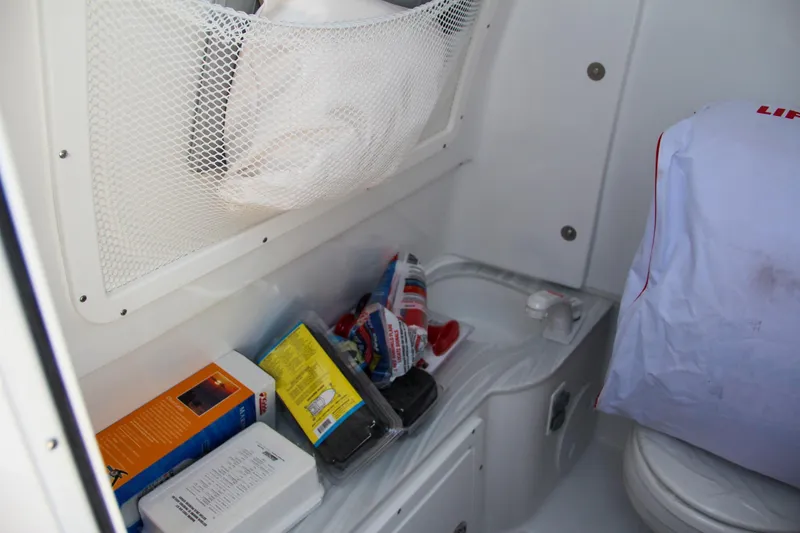 Slide: The Image of Interior storage of 2025 Sea Hunt Gamefish 28 boat with supplies and life jacket. - 39