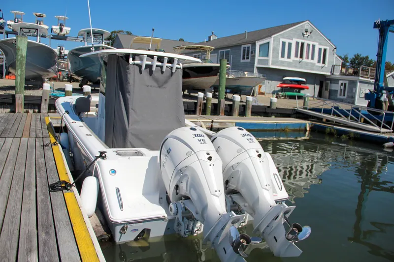 Slide: The Image of 2025 Sea Hunt Gamefish 28 boat docked with twin engines in a marina. - 4