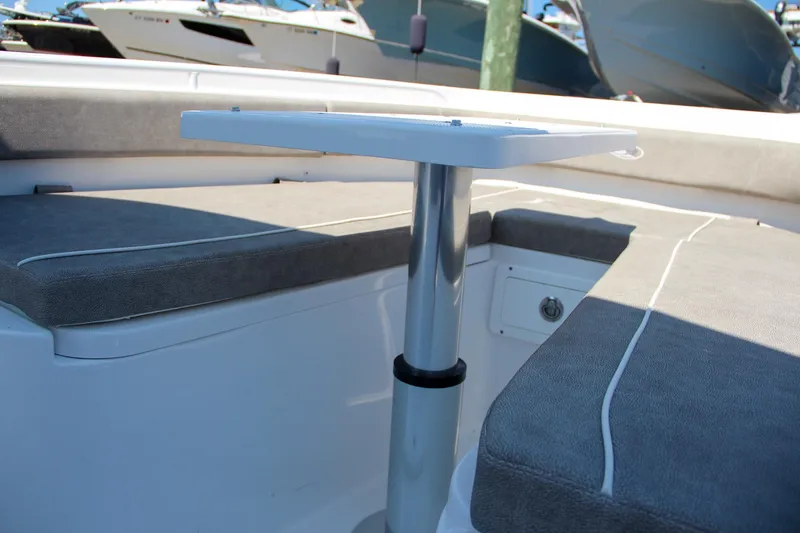 Slide: The Image of 2025 Sea Hunt Gamefish 28 boat interior with cushioned seating and table. - 47