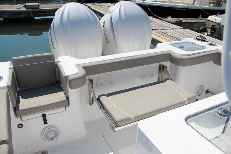 Slide: The Image of 2025 Sea Hunt Gamefish 28 boat interior with seating and dual outboard motors. - 5